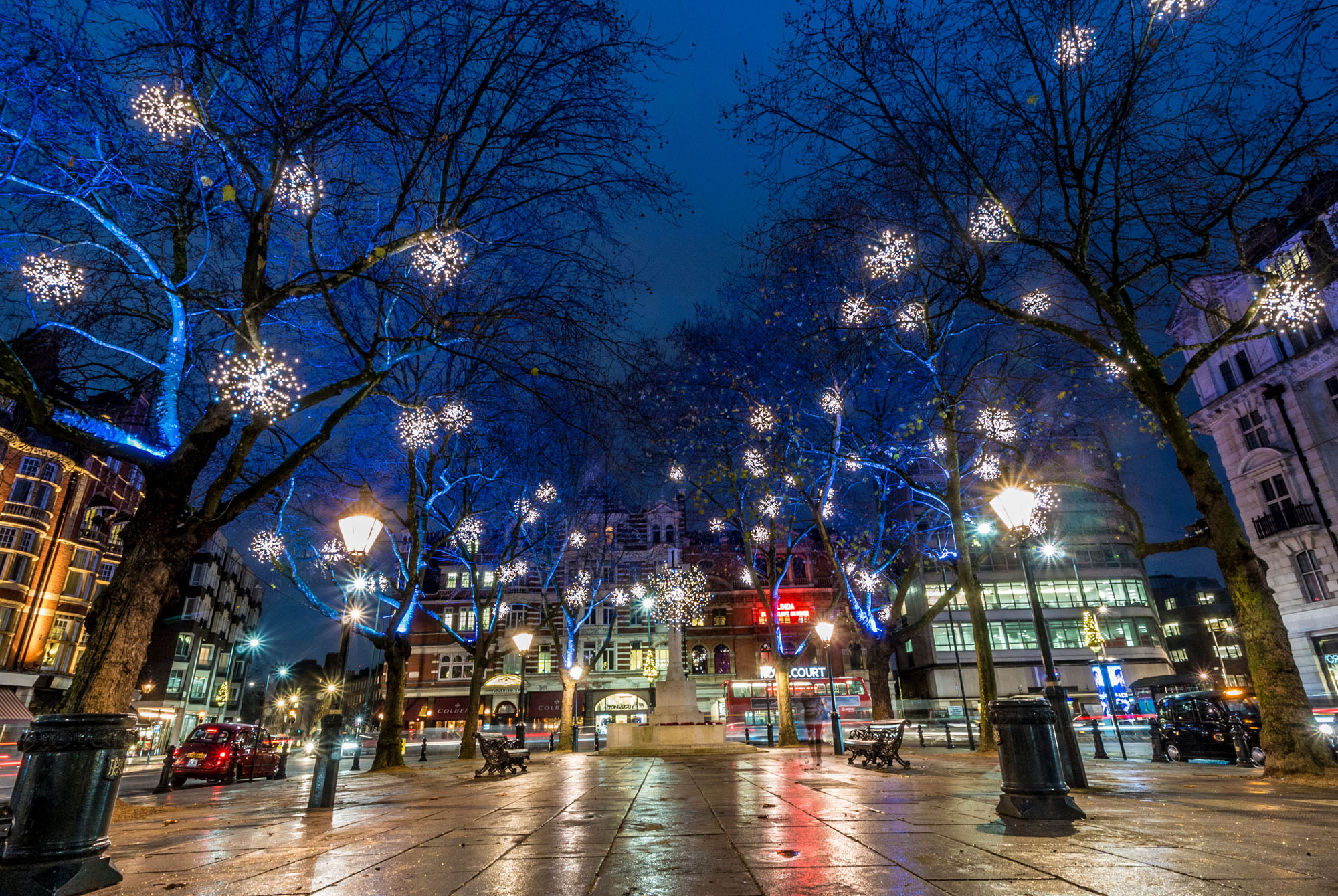 Wide-angle lens capturing expansive scenes of Christmas streetscape.