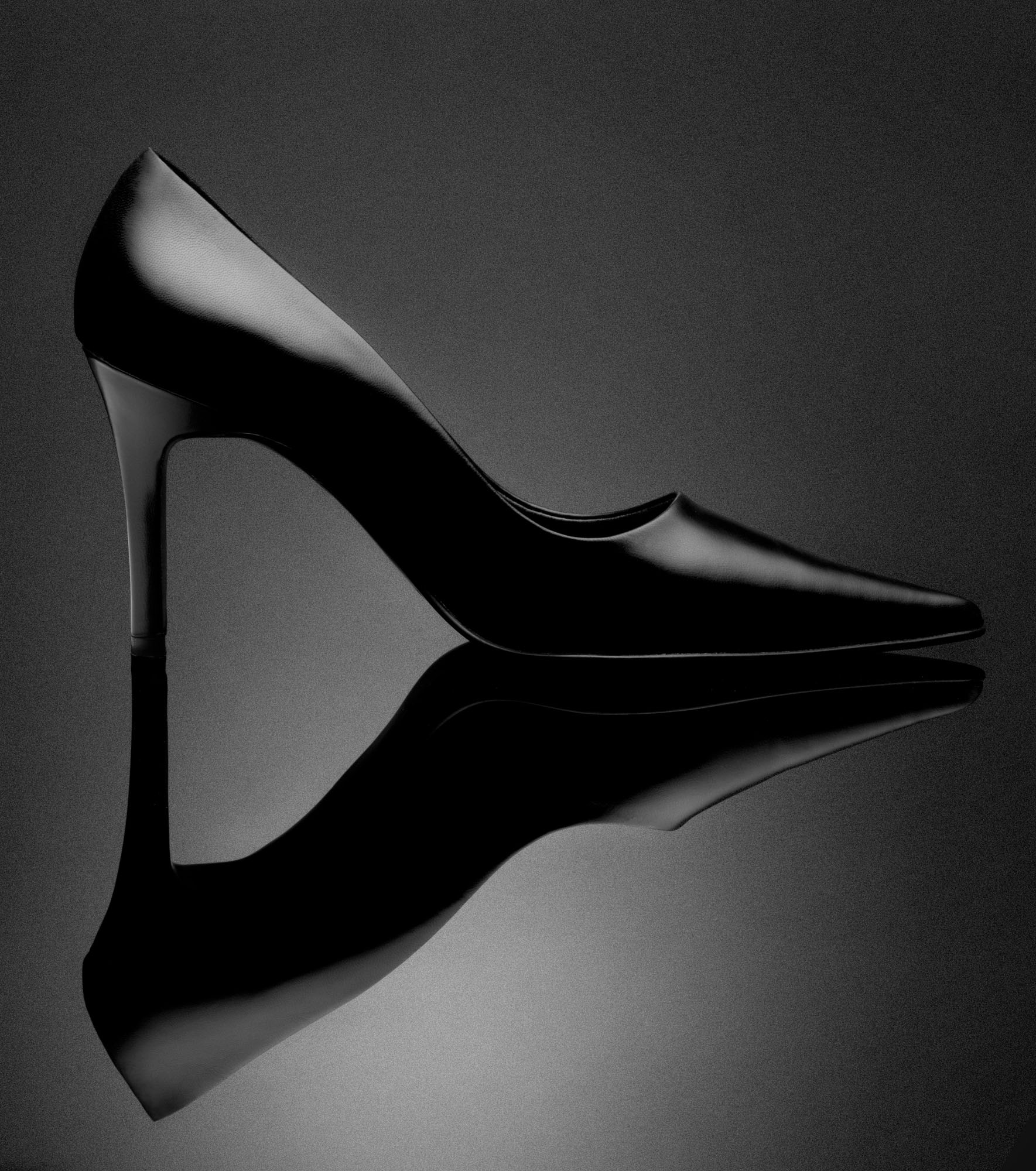 Reflection from a shoe shot on a shiny surface creating symmetry.