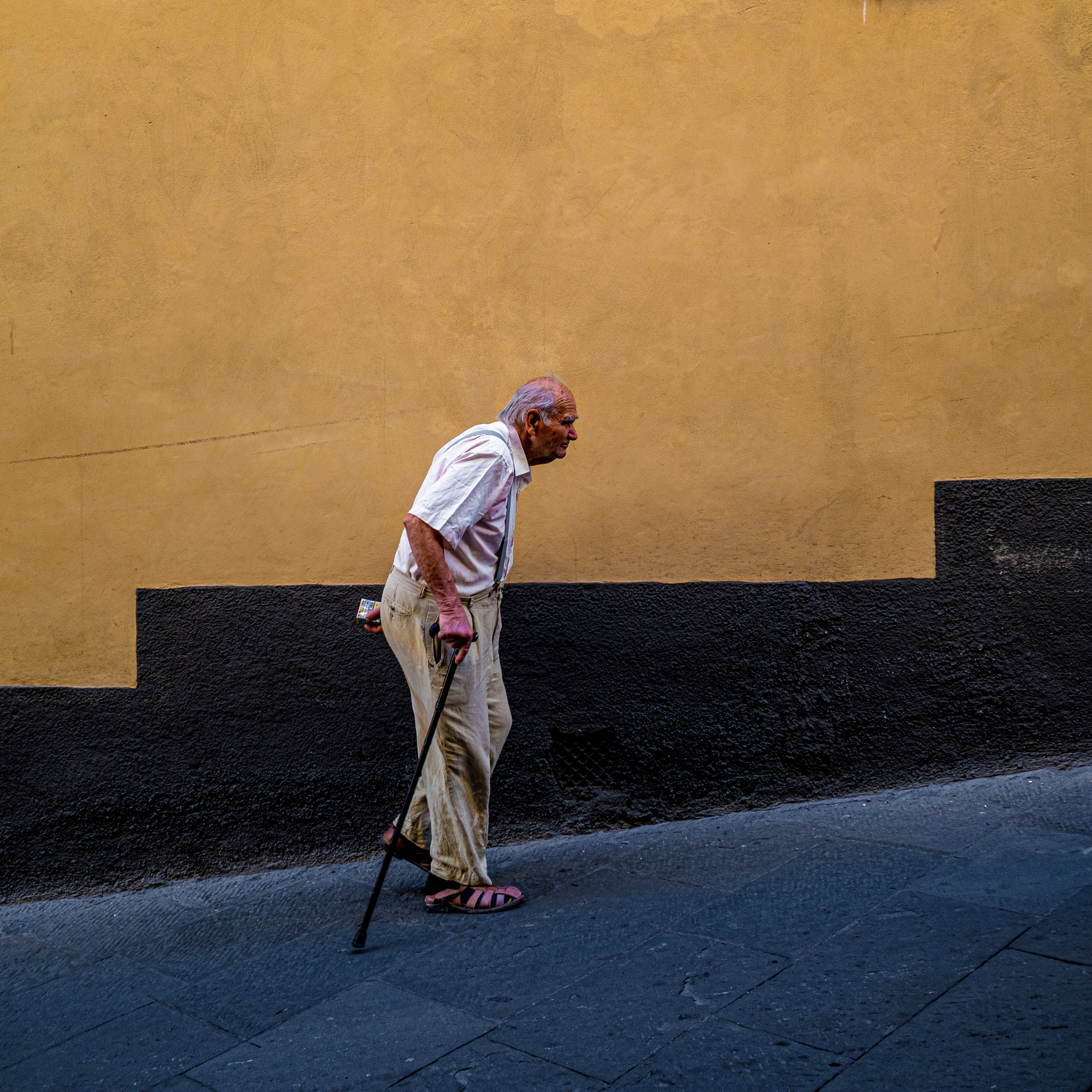 Elderly man walking, an example of street photography.