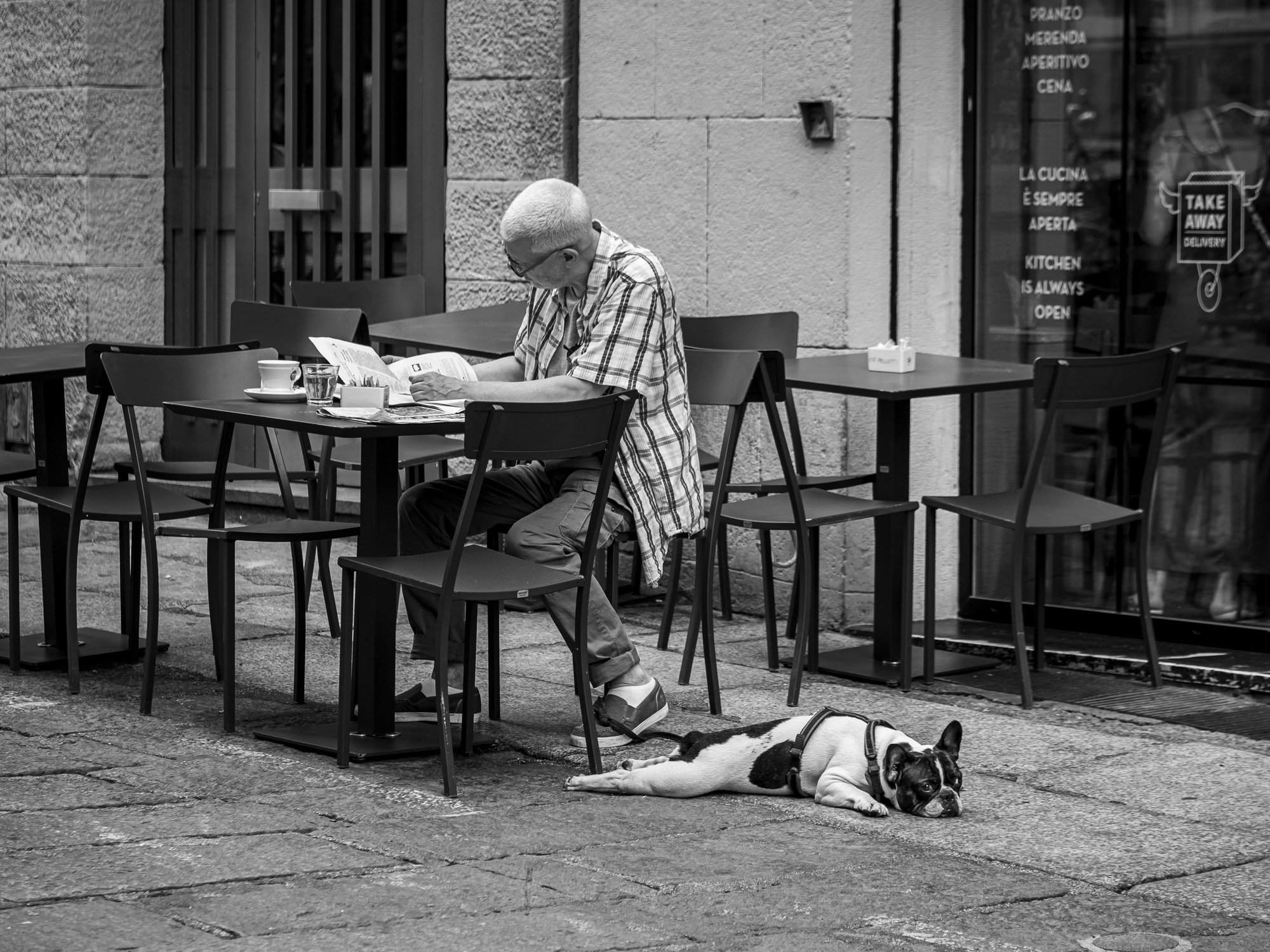 Example of street photography, man at pavement cafe.